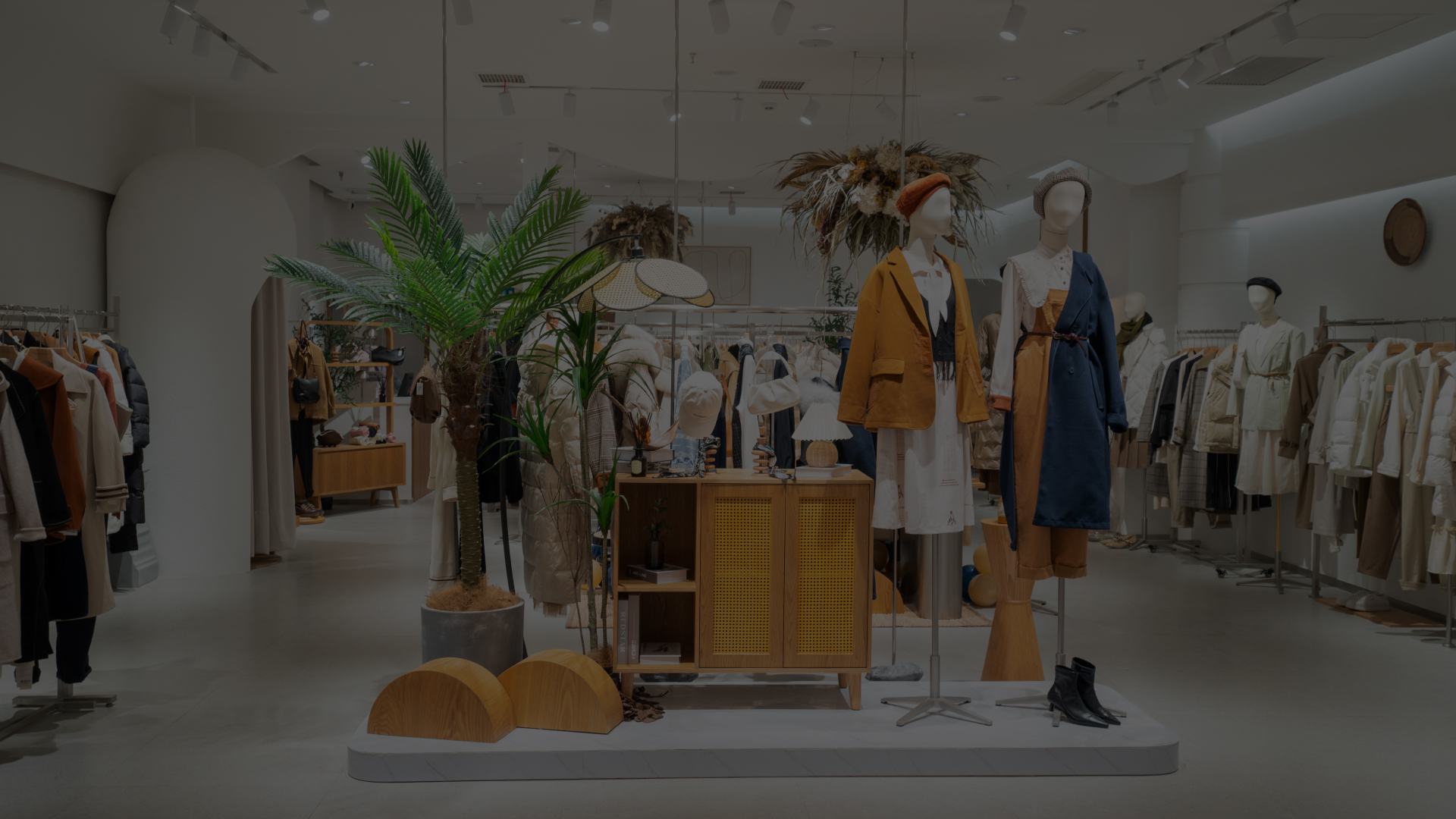 Clothing store with mannequins and tropical decor