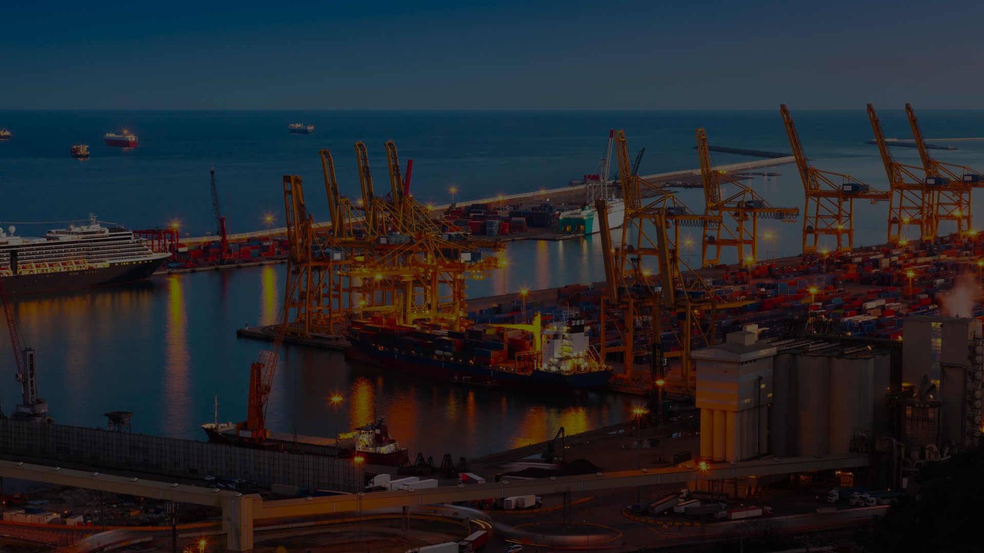 Container ships and cranes at a bustling port during sunset