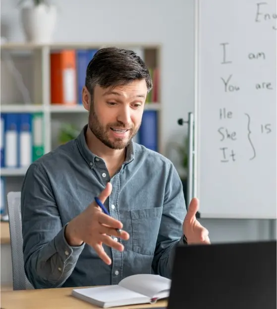 Instructor using education software to teach online with laptop and whiteboard