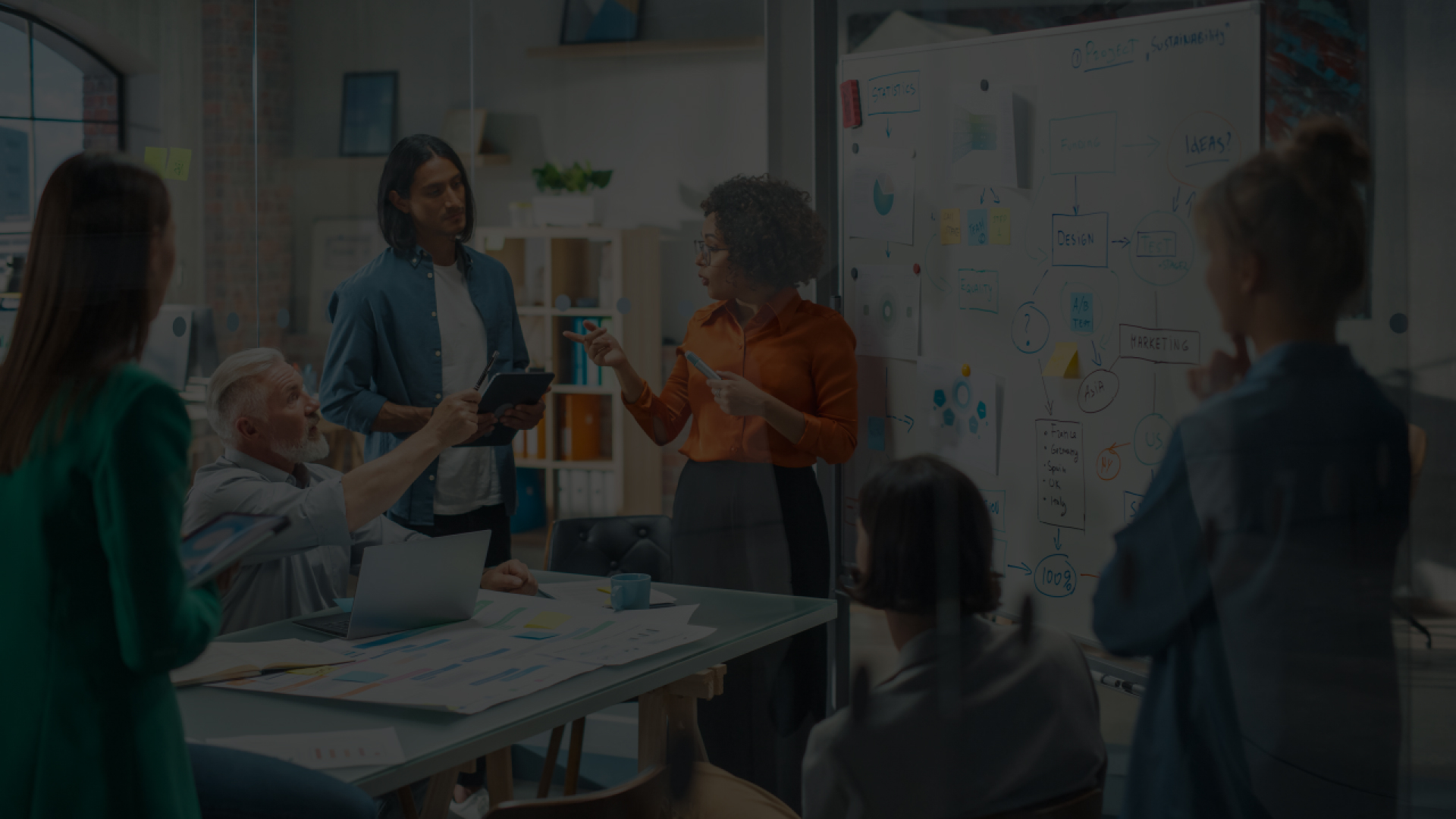Team collaborating in a modern office with a whiteboard