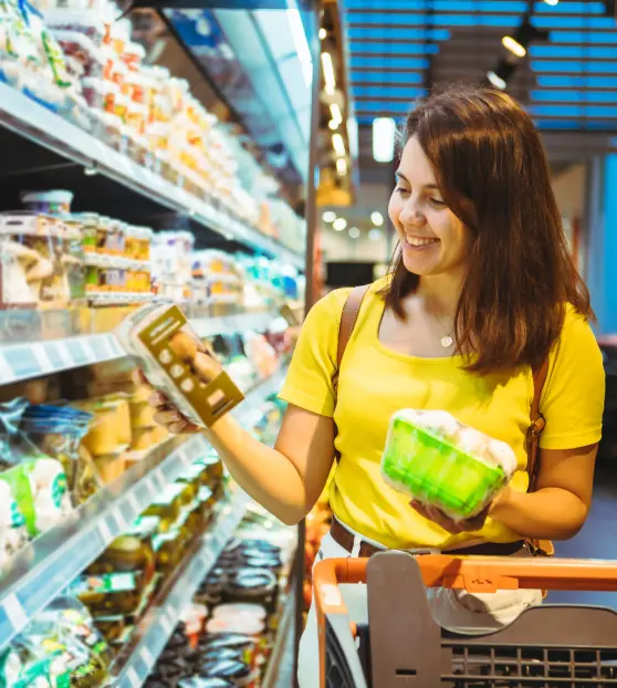 Woman in a yellow shirt shopping at a grocery store