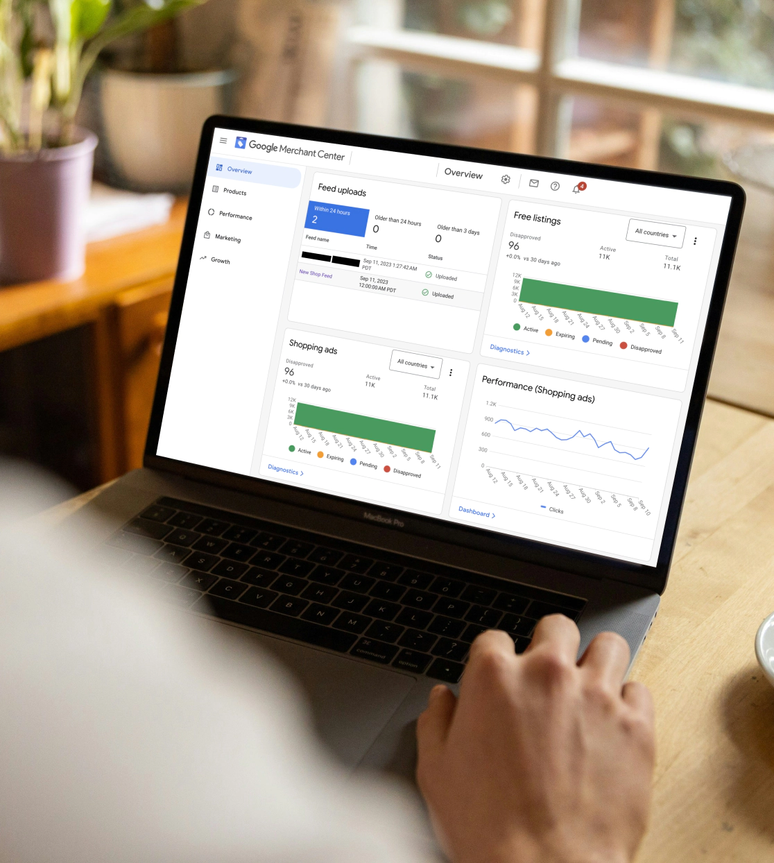 Person using Google Merchant Center on a laptop
