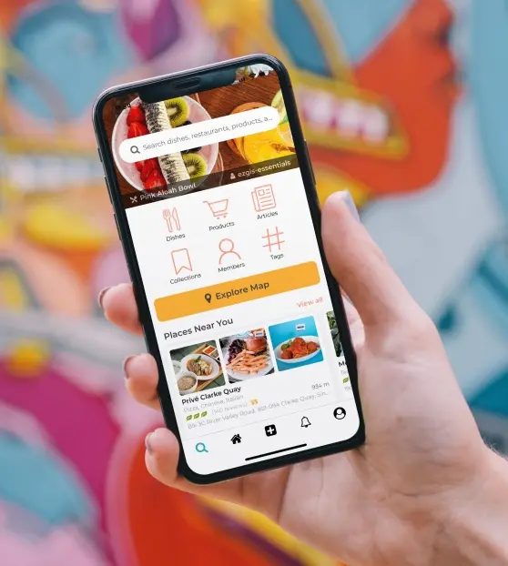 Hand holding a smartphone with a food app open