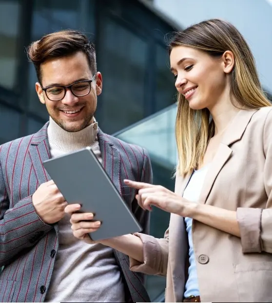 Two professionals discussing content on a tablet