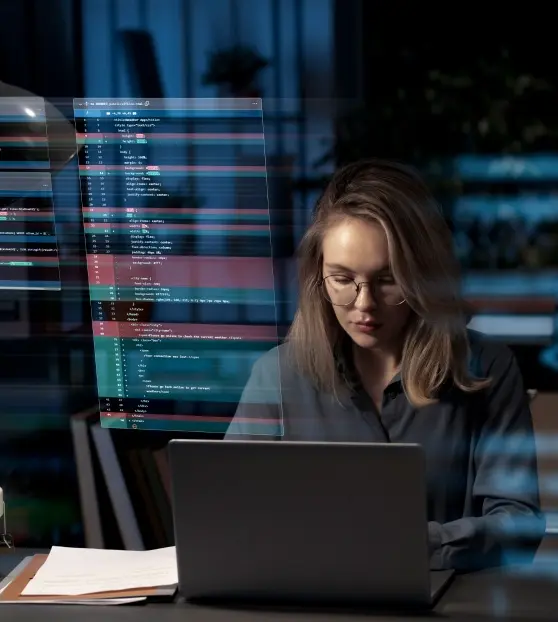 Woman coding on a laptop at night for SaaS