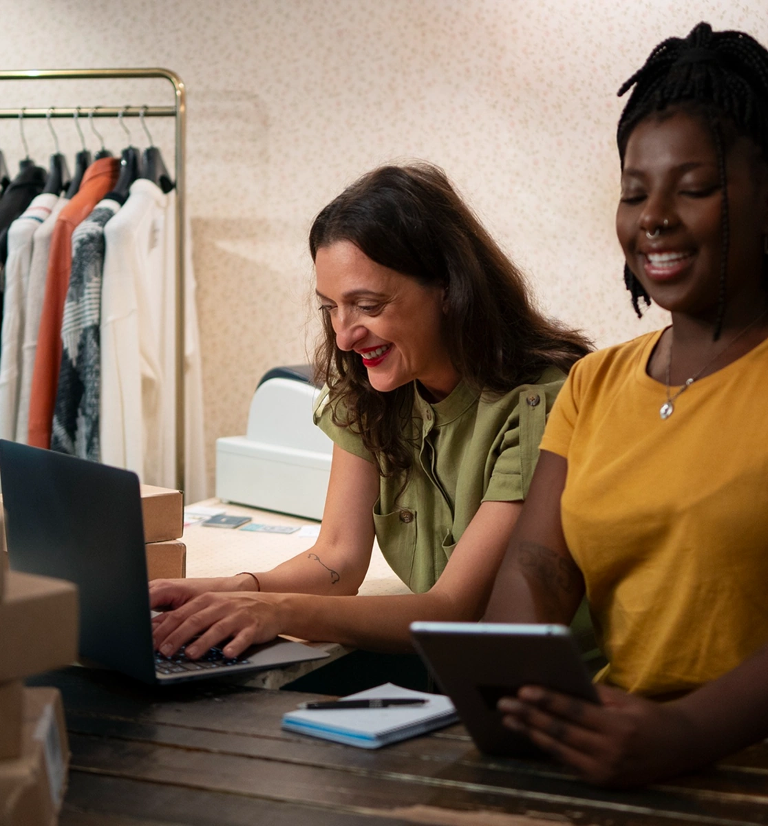 Two women managing online orders in a clothing store